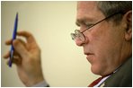 Sketching notes in the margin of speech drafts, President Bush rewrites portions of the address in the Oval Office Jan. 23, 2003. 