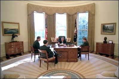 President George W. Bush prepares his State of the Union Address with White House speechwriters Matthew Scully, left, Mike Gerson, center, and John McConnell in the Oval Office Jan. 23, 2003.
