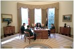 President George W. Bush prepares his State of the Union Address with White House speechwriters Matthew Scully, left, Mike Gerson, center, and John McConnell in the Oval Office Jan. 23, 2003.