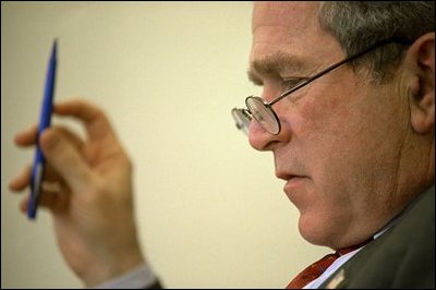 Sketching notes in the margin of speech drafts, President Bush rewrites portions of the address in the Oval Office Jan. 23, 2003. 