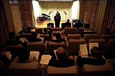 Each prepared with their own draft of the State of the Union Address, a select group of advisers listen to President Bush’s delivery of his speech in the family theater of the White House Jan. 24, 2003.