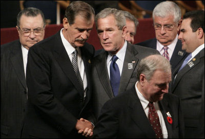 President George W. Bush spends a moment with Mexico's President Vicente Fox following the opening ceremonies Friday, Nov. 4, 2005, of the 2005 Summit of the Americas at the Teatro Auditorium in Mar del Plata, Argentina.