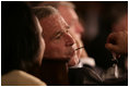 President George W. Bush listens to Secretary of State Condoleezza Rice during the opening session Friday, Nov. 4, 2005, of the 2005 Summit of the Americas in Mar del Plata, Argentina.