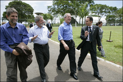 President George W. Bush enjoys a walk with Brazilian President Luiz Inacio Lula da Sliva following their joint statement at the Granja do Torto in Brasila, Brazil, Sunday, Nov. 6, 2005. 