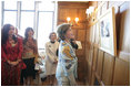 Mrs. Laura Bush looks over a photographic exhibit during a luncheon in Mar del Plata Saturday, Nov. 5, 2005, hosted by Argentine First Lady Mrs. Cristina Fernandez de Kirchner, far left. 