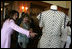 Mrs. Laura Bush is shown a dress worn by former Argentine First Lady Eva Peron as the U.S. First Lady participated in a luncheon Saturday, Nov. 5, 2005, in Mar del Plata that included a display of important Argentine women. 