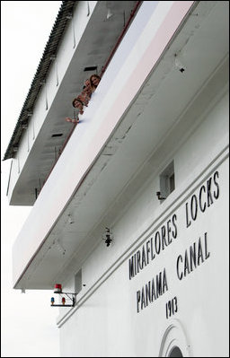 President George W. Bush, Mrs. Laura Bush, Panama's President Martin Torrijos and his wife, Vivian Torrijos, peek out from atop the Miraflores Locks Visitor's Center Monday, Nov. 7, 2005, in Panama City, Panama. 