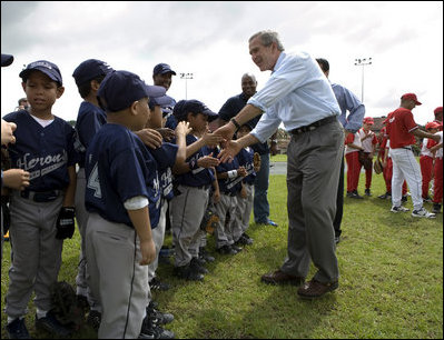 President George W. Bush greets players from the Meron's Academy Little League team in Panama City, Panama, Monday, Nov. 7, 2005. 