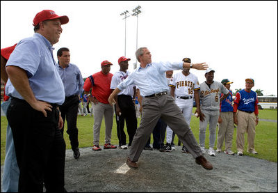 President George W. Bush delivers a pitch from the mound during a baseball event with Major League baseball players and Panamanian youth, Monday, Nov. 7, 2005 in Panama City, Panama. 