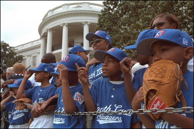 The Memphis Red Sox of the Satchel Paige Little League in Washington, D.C. watch as the President arrives May 6, 2001.