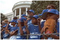 The Memphis Red Sox of the Satchel Paige Little League in Washington, D.C. watch as the President arrives May 6, 2001.