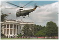 President George W. Bush arrives aboard Marine One from Camp David for the tee-ball game on the South Lawn event Sunday, May 7, 2001.