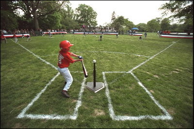 A Rockies player swings during a tee-ball game on the South Lawn May 6, 2001. The Rockies are part of Capitol City Little League in Washington, D.C.