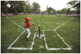 A Rockies player swings during a tee-ball game on the South Lawn May 6, 2001. The Rockies are part of Capitol City Little League in Washington, D.C.