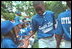 Players congratulate each other in the dugout during the second Tee Ball game on the South Lawn on Sunday, June 3, 2001.