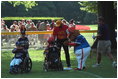With coaches and a big furry mascot on hand, the bases were always loaded with activity during the third Tee Ball game on the South Lawn on Sunday, July 15, 2001.