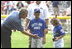 President George W. Bush hosts a White House Tee Ball (t-ball) game on the South Lawn between the Waynesboro, Virginia Little League Challenger Division Sand Gnats (Blue Team) vs. the East Brunswick, New Jersey Babe Ruth Buddy Ball League Sluggers (Red Team) September 22, 2002.