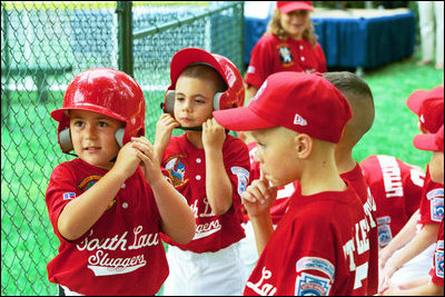 Suited up in red, the Cherry Point Marine Corps Air Station Devil Dogs prepare for their turn at bat during a game against the Bolling Air Force Base Little League Cardinals June 13, 2004. The Devil Dogs hail from Havelock, N.C., and the Cardinals are from Washington, D.C.
