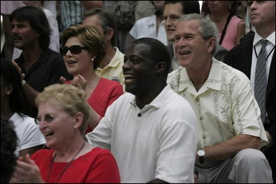 President George W. Bush and First Lady Laura Bush watch the Challenger Phillies of M.O.T. Little League from Middletown, Delaware take on the Challenger Yankees of Lancaster County Little Leagues from Lancaster County, Pennsylvania at Tee Ball on the South Lawn at the White House on Sunday July 11, 2004.