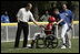 Former Major League pitcher Jim Abbott congratulates a player from the Challenger Phillies from Middletown, Delaware at Tee Ball on the South Lawn at the White House on Sunday July 11, 2004.