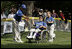A player from the District 12 Little League Challengers from Williamsport, PA is helped to home plate by her buddy during a Tee Ball game on the South Lawn of the White House on Sunday July 24, 2005.