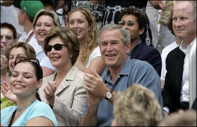 President George W. Bush and Mrs. Laura Bush cheers on players during a Tee Ball game on the South Lawn of the White House between the District 12 Little League Challengers from Williamsport, PA and the West University Little League Challengers from Houston, Texas on Sunday July 24, 2005.