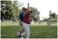 A player from the West University Little League Challengers from Houston, Texas cheers after scoring a run during a game on the South Lawn of the White House on Sunday July 24, 2005.