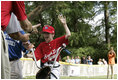 A player from the West University Little League Challengers from Houston, Texas, is welcomed as he crosses homeplate to score a run, Sunday, July 24, 2005, during a Tee Ball game on the South Lawn of the White House.