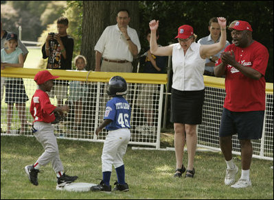 Secretary of Education Margaret Spellings is on her toes as she declares safe at first Naji Loggins of the Newark (New Jersey) Black Yankees after Naji singled during "Tee Ball on the South Lawn."