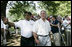 Baseball legend and hall of famer Willie Mays walks with President George W. Bush as he acknowledges a standing ovation from the crowd Sunday, July 30, 2006, upon their arrival for the Tee Ball on the South Lawn game between the Thurmont Little League Civitan Club of Frederick Challengers of Thurmont, Md., and the Shady Spring Little League Challenger Braves of Shady Spring, W. Va. Mays was the honorary Tee Ball Commissioner for the game. 