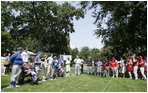President George W. Bush welcomes players and guests to the White House Sunday, July 30, 2006, for the Tee Ball on the South Lawn game between the Thurmont Little League Civitan Club of Frederick Challengers of Thurmont, Md., and the Shady Spring Little League Challenger Braves of Shady Spring, W. Va.