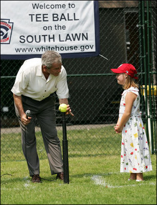 Under the watchful eye of Meredith Cripe, a member of the Chantilly, Virginia Little League Challenger League, President George W. Bush places a ball on the tee to start the game and the 2007 White House Tee Ball Season on the South Lawn. The game pitted the Bobcats from Cumberland, Maryland, against the Red Wings of Luray, Virginia. 