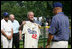 President George W. Bush holds up a commemorative baseball jersey with Jackie Robinson's number 42 presented to him by players from Robinson's playing era at the White House Tee Ball Game Sunday, July 15, 2007. Tee Ball players wore the number 42 to celebrate the legacy of Jackie Robinson.