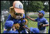 Players from the Inner City Little League of Brooklyn, N.Y. give a group hug to Dugout, the Little League mascot Sunday, July 15, 2007 at the White House Tee Ball Game, played in honor of baseball legend Jackie Robinson between Inner City and the Wrigley Little League Dodgers of Los Angeles.