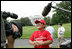 A player with the Cramer Hill Little League Red Sox of Camden, N.J., is the center of media attention on the South Lawn of the White House after playing Monday, June 30, 2008, in the opening game of the 2008 Tee Ball on the South Lawn, with his teammates against the Jose M. Rodriguez Little League Angels of Manatí, Puerto Rico.