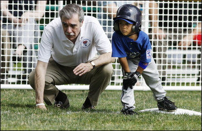 U.S. Secretary of Commerce Carlos Gutierrez coaches a player on third base of the Jose M. Rodriguez Little League Angels of Manatí, Puerto Rico, during the 2008 Tee Ball on the South Lawn Season Opener Monday, June 30, 2008, on the South Lawn of the White House.