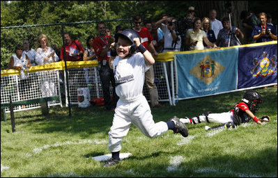  Five-year-old Alex Thaler of the Eastern U.S. All-Stars makes a valiant effort as Jackson McGough of the Central U.S. All-Stars crosses the plate Wednesday, July 16, 2008, during All-Star Tee Ball at the White House. Players from across the United States gathered for the first time on the White House lawn to play the doubleheader that matched the Southern U.S. against the Western U.S. in the second game.