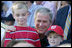  President George W. Bush poses for photos with two youngsters at the Tee Ball on the South Lawn: A Salute to the Troops game Sunday, Sept. 7, 2008, played by the children of active-duty military personnel.