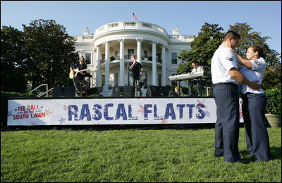  A couple dances as the The Rascal Flatts entertain guests on the South Lawn of the White House following the Tee Ball on the South Lawn: A Salute to the Troops game Sunday, Sept. 7, 2008 at the White House. The Tee Ball game was played by the children of active-duty military personnel in honor of the nation's military personnel.