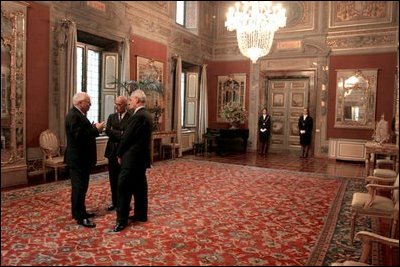 Vice President Dick Cheney talks with Antonio Malaschini, Secretary General of the Italian Senate, center, and Marcello Pera, President of the Italian Senate, right, during a reception in the Palazzo Giustiniani in Rome Jan. 26, 2004.
