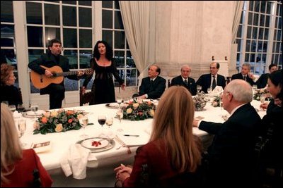 An Italian opera singer serenades guests at a dinner hosted by Prime Minister Silvio Berlusconi honoring Vice President Dick Cheney in Rome Jan. 26, 2004.