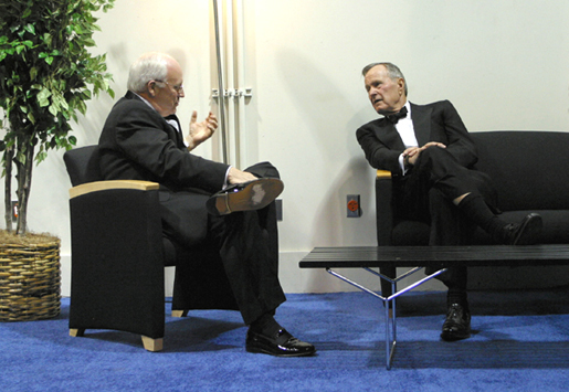 Vice President Dick Cheney talks with former President George H. W. Bush before presenting him with the National Defense University Foundation's American Patriot Award in Washington, D.C., Dec. 6, 2002. The Vice President served under the former president as secretary of defense. White House photo by David Bohrer.