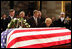 Former first lady Betty Ford kneels at the casket of her husband, former President Gerald R. Ford, in the U.S. Capitol rotunda during the State Funeral ceremony, Saturday, December 30, 2006. Accompanying Mrs. Ford are her children, from left, John G. Ford, Susan Ford Bales, Michael Ford and Steven Ford.