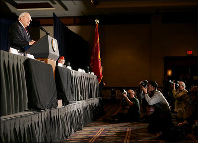 Press photographers steady their cameras as Vice President Dick Cheney delivers remarks to members of the American Legion, a community-service organization made up of nearly three million war-time veterans, during the organization's annual conference in Washington, Tuesday, February 28, 2006.