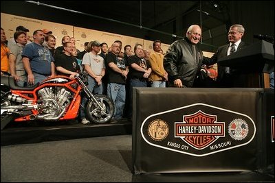 Vice President Dick Cheney wears a leather jacket given to him by Harley-Davidson CEO Jim Ziemer after touring the motorcycle plant and delivering remarks to the company’s employees in Kansas City, Friday January 6, 2006. During his remarks the Vice President said, “To have the experience of visiting this Harley-Davidson plant is to see, collected under one roof, so much of what is best in the American economy: the hard work, the commitment to quality, and the optimism that drives us forward.”