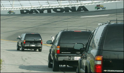 The motorcade of Vice President Dick Cheney takes a lap around the Daytona International Speedway in Daytona, Fla., Saturday, July 1, 2006, as the Vice President arrived to attend the 2006 Pepsi 400 NASCAR race.