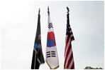 An honor guard composed of Korean War veterans holds flags prior to the start of the 2006 Korean War Veterans Armistice Day Ceremony held at the Korean War Memorial on the National Mall in Washington, D.C., Thursday, July 27, 2006.