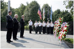 Vice President Dick Cheney stands with Secretary of the Interior Dirk Kempthorne, right, and South Korean Ambassador to the U.S. Tae Sik Lee, left, during a moment of silence after placing a wreath at the Korean War Memorial in Washington, D.C. to commemorate Korean War Veterans Armistice Day, Thursday, July 27, 2006. Today marks the 53rd anniversary of the end of the Korean War.