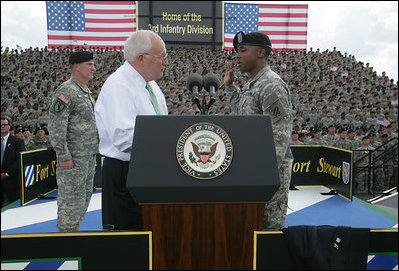 Vice President Dick Cheney administers the Ceremonial Oath of Re-enlistment of Corporal Jarrod Fields, at a rally for the troops at Fort Stewart, Ga., Friday, July 21, 2006. Cpl. Fields was wounded by an improvised explosive device in 2005 while serving in Iraq with the 3rd Infantry Division.