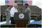 Vice President Dick Cheney administers the Ceremonial Oath of Re-enlistment of Corporal Jarrod Fields, at a rally for the troops at Fort Stewart, Ga., Friday, July 21, 2006. Cpl. Fields was wounded by an improvised explosive device in 2005 while serving in Iraq with the 3rd Infantry Division.